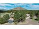 Aerial view of the home showcasing mountain views and surrounded by pine trees at 3842 Estates Cir, Larkspur, CO 80118