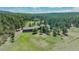 Scenic aerial view of the property showcasing lush greenery and surrounding landscape at 3842 Estates Cir, Larkspur, CO 80118