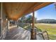 Covered back porch with stone columns offers scenic views of the surrounding landscape at 3842 Estates Cir, Larkspur, CO 80118