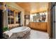 Luxurious bathroom featuring a soaking tub, dual vanities, and stone accents, creating a spa-like experience at 3842 Estates Cir, Larkspur, CO 80118