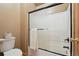 Standard bathroom with a toilet and shower with black-framed sliding door at 3842 Estates Cir, Larkspur, CO 80118