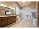 Elegant bathroom with dual sinks, granite countertops, and a tiled walk-in shower at 3842 Estates Cir, Larkspur, CO 80118