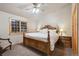 Bedroom with a bed and nightstand plus a large window with natural lighting at 3842 Estates Cir, Larkspur, CO 80118