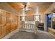 Cozy bedroom with wood-framed bed, matching nightstands, and wood ceiling at 3842 Estates Cir, Larkspur, CO 80118