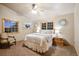 Comfortable bedroom featuring two windows, ceiling fan, carpet flooring and comfortable furniture at 3842 Estates Cir, Larkspur, CO 80118