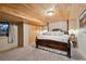Charming bedroom with a king bed, bedside lamps, closet, and wood ceilings at 3842 Estates Cir, Larkspur, CO 80118