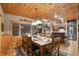 Dining area featuring a rustic wooden table, views into the kitchen, and wood ceilings at 3842 Estates Cir, Larkspur, CO 80118