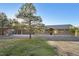 Charming single-story home with a three car garage, stone accents, and a well-manicured lawn at 3842 Estates Cir, Larkspur, CO 80118