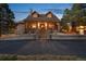 Charming home exterior with a stone facade, covered porch, and well-maintained landscaping at 3842 Estates Cir, Larkspur, CO 80118