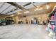Expansive garage with high ceilings, ample space for vehicles, and workshop areas at 3842 Estates Cir, Larkspur, CO 80118
