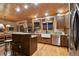Stylish kitchen featuring a center island, stainless steel appliances, and custom cabinetry at 3842 Estates Cir, Larkspur, CO 80118