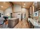 Well-designed kitchen with a center island, granite countertops, and wood-look flooring at 3842 Estates Cir, Larkspur, CO 80118