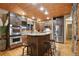 Modern kitchen with wooden cabinets, stainless steel appliances, and granite countertops at 3842 Estates Cir, Larkspur, CO 80118