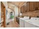 Convenient laundry room with a sink, cabinets, and modern washer and dryer units at 3842 Estates Cir, Larkspur, CO 80118