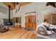 Inviting living room with wood-burning fireplace, wood floors and natural light at 3842 Estates Cir, Larkspur, CO 80118