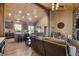 Open floor plan with a kitchen island adjacent to a living room with vaulted wood ceilings at 3842 Estates Cir, Larkspur, CO 80118