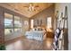 Spacious main bedroom with wood ceilings and a large window showcasing the surrounding landscape at 3842 Estates Cir, Larkspur, CO 80118