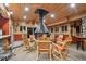 Inviting patio with a central fireplace, comfortable seating, and rustic charm at 3842 Estates Cir, Larkspur, CO 80118