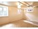 Bright, carpeted basement space with natural light from multiple windows, ideal for a bonus room at 723 Steele St, Denver, CO 80206