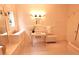 Bright bathroom with white tile, window, classic fixtures, and radiator at 723 Steele St, Denver, CO 80206