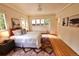 Comfortable bedroom featuring neutral tones, hardwood floors, and many windows overlooking the outside at 723 Steele St, Denver, CO 80206