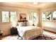 Comfortable bedroom featuring neutral tones, hardwood floors, and many windows overlooking the outside at 723 Steele St, Denver, CO 80206