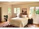 Comfortable bedroom featuring neutral tones, hardwood floors, and many windows overlooking the outside at 723 Steele St, Denver, CO 80206