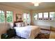 Cozy bedroom with large windows, hardwood floors, and neutral decor offering a tranquil retreat at 723 Steele St, Denver, CO 80206