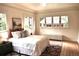 Comfortable bedroom featuring neutral tones, hardwood floors, and many windows overlooking the outside at 723 Steele St, Denver, CO 80206