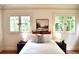 Comfortable bedroom featuring neutral tones, hardwood floors, and many windows overlooking the outside at 723 Steele St, Denver, CO 80206