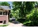 Long driveway leading to the home, framed by mature trees and lush landscaping at 723 Steele St, Denver, CO 80206