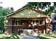 Charming brick home with Craftsman details, inviting front porch and well-maintained landscaping in a quiet neighborhood at 723 Steele St, Denver, CO 80206