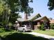 Beautiful home showcasing brick exterior, well-manicured lawn, and a convenient driveway at 723 Steele St, Denver, CO 80206