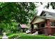 Charming brick home with lush green lawn, mature trees, and inviting front entry at 723 Steele St, Denver, CO 80206