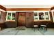 Inviting front porch with brick accents, seating, and a stylish wood door at 723 Steele St, Denver, CO 80206