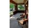 Charming covered front porch with wicker chairs, offering a relaxing outdoor space with beautiful brick and tree-lined street views at 723 Steele St, Denver, CO 80206