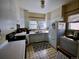 Functional kitchen with white appliances, neutral tile, and plenty of natural light at 723 Steele St, Denver, CO 80206