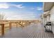 Expansive back deck with wood railing, providing open views and featuring an outdoor grill and table at 44011 Morning Star Ct, Elizabeth, CO 80107