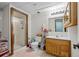 Cozy bathroom featuring a framed glass shower, wood vanity, neutral walls, and tile flooring at 44011 Morning Star Ct, Elizabeth, CO 80107