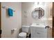Compact half bathroom features a white vanity and mirror at 44011 Morning Star Ct, Elizabeth, CO 80107