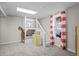 Carpeted bedroom features a white loft bed, playful decor, and a bright window with striped curtains at 44011 Morning Star Ct, Elizabeth, CO 80107