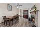Inviting dining area featuring a stone fireplace and hardwood floors at 44011 Morning Star Ct, Elizabeth, CO 80107