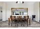 This dining room features hardwood floors and a wooden table and chairs with a large mirror on the wall at 44011 Morning Star Ct, Elizabeth, CO 80107