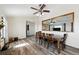 The open-concept dining room features laminate flooring, a ceiling fan, and is adjacent to the living room at 44011 Morning Star Ct, Elizabeth, CO 80107