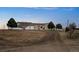 Ranch home with long driveway; features include a two-car garage, manicured trees, and propane tank at 44011 Morning Star Ct, Elizabeth, CO 80107