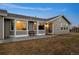 Home featuring gray siding, updated windows, and outdoor seating on a paver patio at 44011 Morning Star Ct, Elizabeth, CO 80107