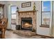 Rustic stone fireplace with a wooden mantel creates a cozy focal point at 44011 Morning Star Ct, Elizabeth, CO 80107