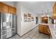 Charming kitchen with stainless steel appliances, wooden cabinets, and tile flooring at 44011 Morning Star Ct, Elizabeth, CO 80107