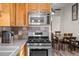 Close-up on kitchen appliances and backsplash, with dining room visible in background at 44011 Morning Star Ct, Elizabeth, CO 80107