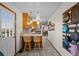 Kitchen area featuring tile flooring, wooden cabinets, and two bar stools at counter at 44011 Morning Star Ct, Elizabeth, CO 80107
